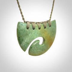 Hand carved New Zealand Flower Jade half-shield with koru pendant.