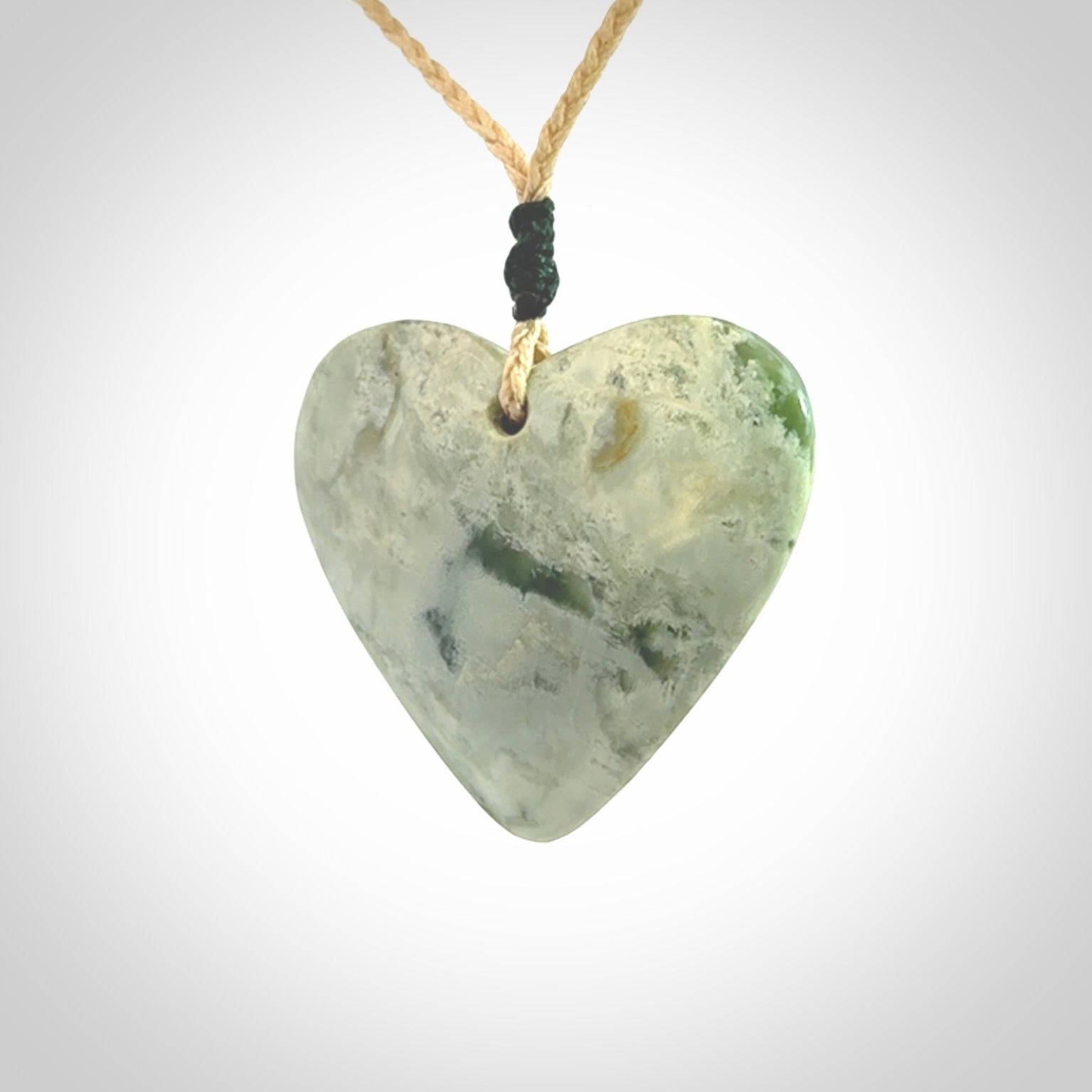 A hand carved heart pendant made from New Zealand jade.