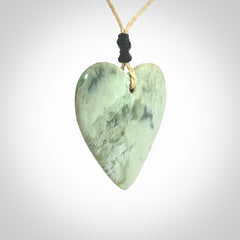 A hand carved heart pendant made from New Zealand jade.