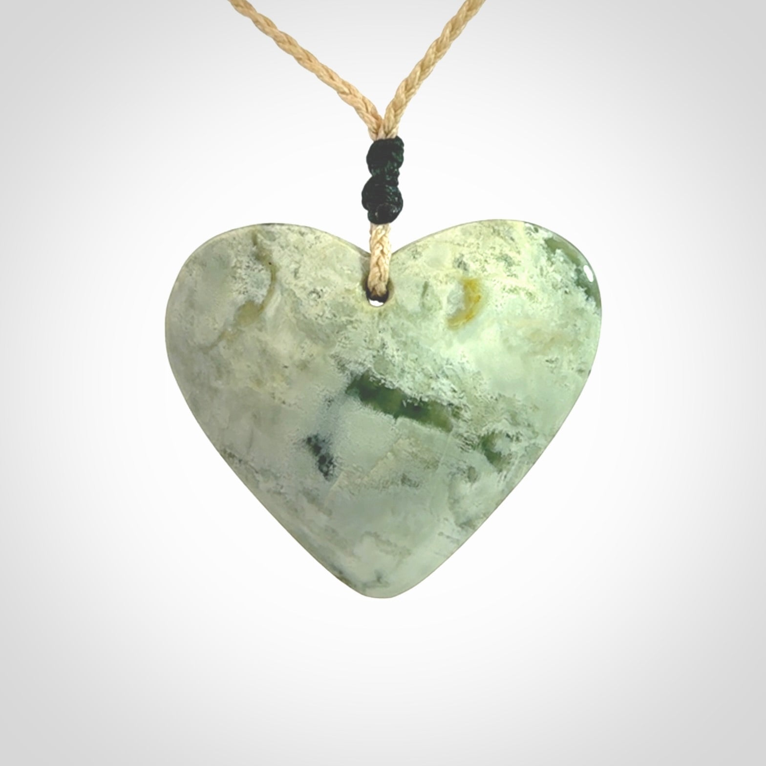 A hand carved heart pendant made from New Zealand jade.