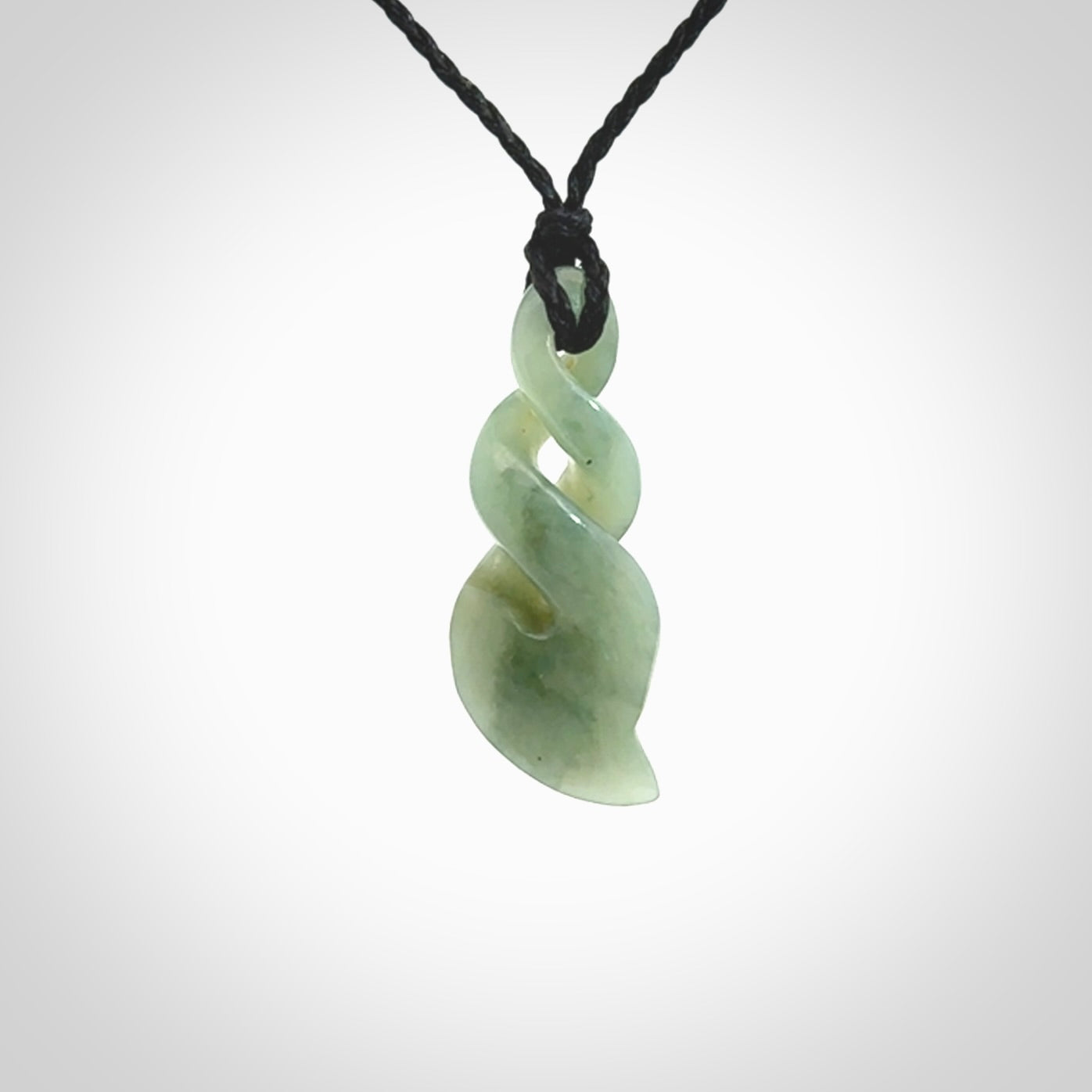 Hand carved small sized, New Zealand Inanga jade double twist pendant.