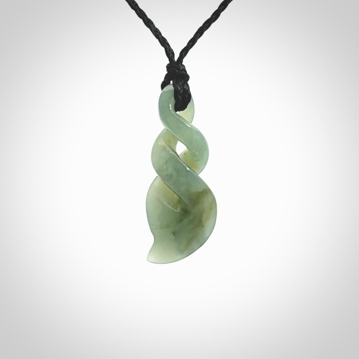 Hand carved small sized, New Zealand Inanga jade double twist pendant.
