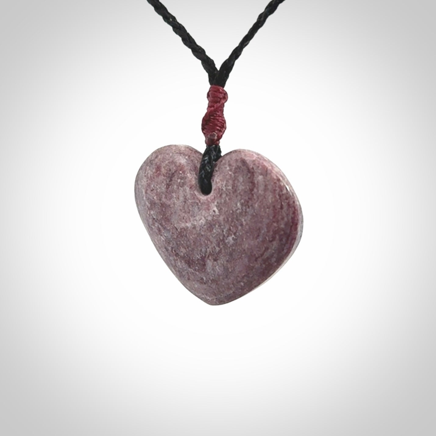 A hand carved heart pendant made from New Zealand Aroha Stone. This is a smaller sized and visually striking piece, beautifully curved and sensuous. The perfect piece of jewellery for someone you love.