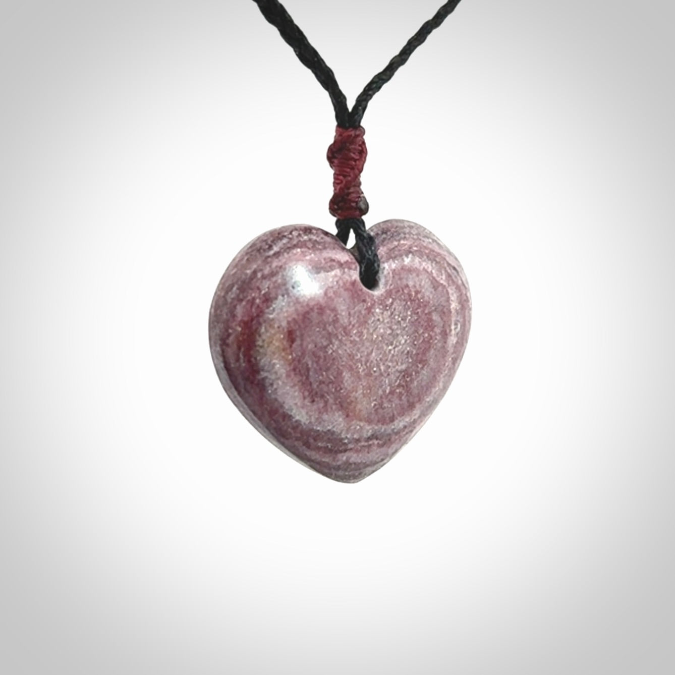 A hand carved heart pendant made from New Zealand Aroha Stone. This is a smaller sized and visually striking piece, beautifully curved and sensuous. The perfect piece of jewellery for someone you love.