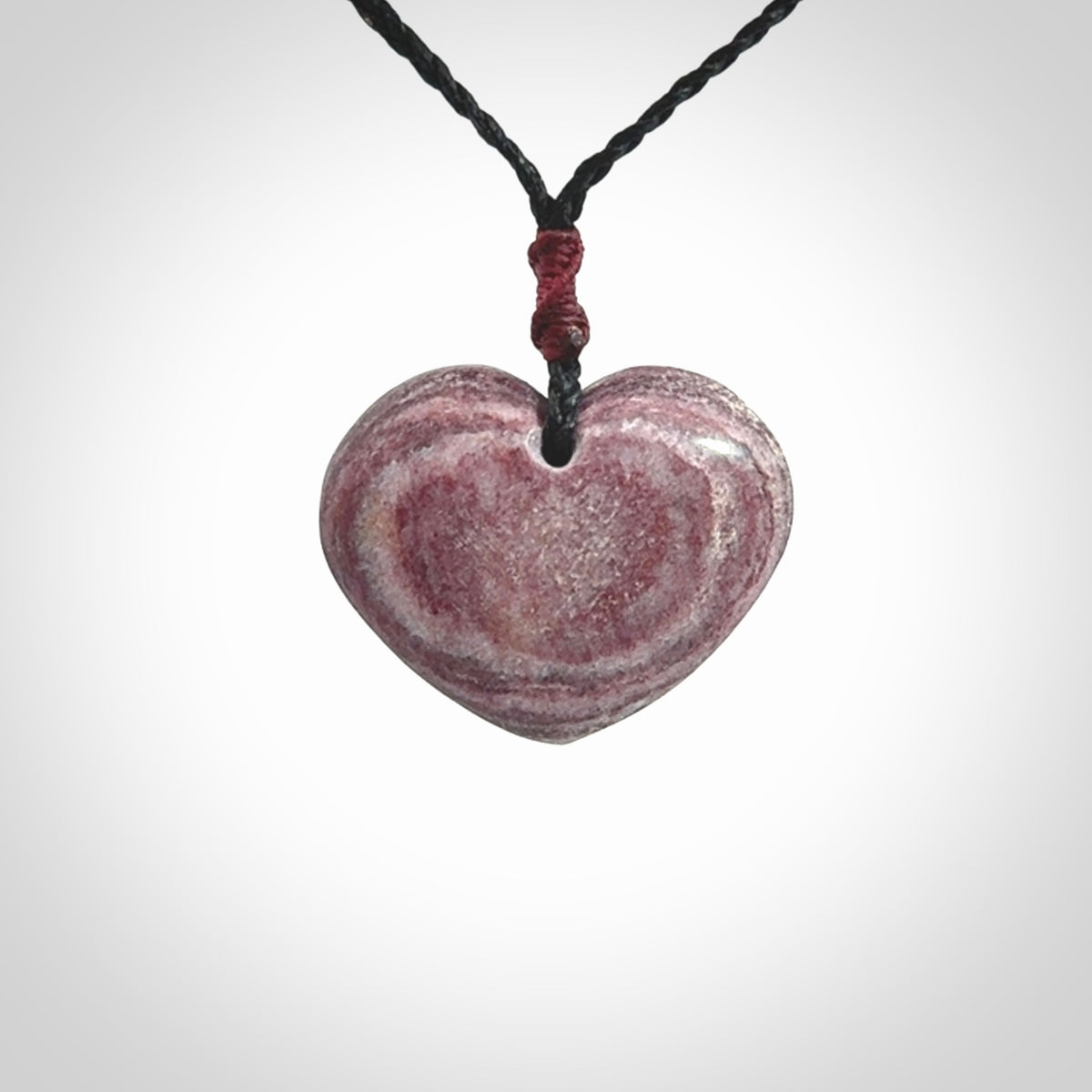 A hand carved heart pendant made from New Zealand Aroha Stone. This is a smaller sized and visually striking piece, beautifully curved and sensuous. The perfect piece of jewellery for someone you love.