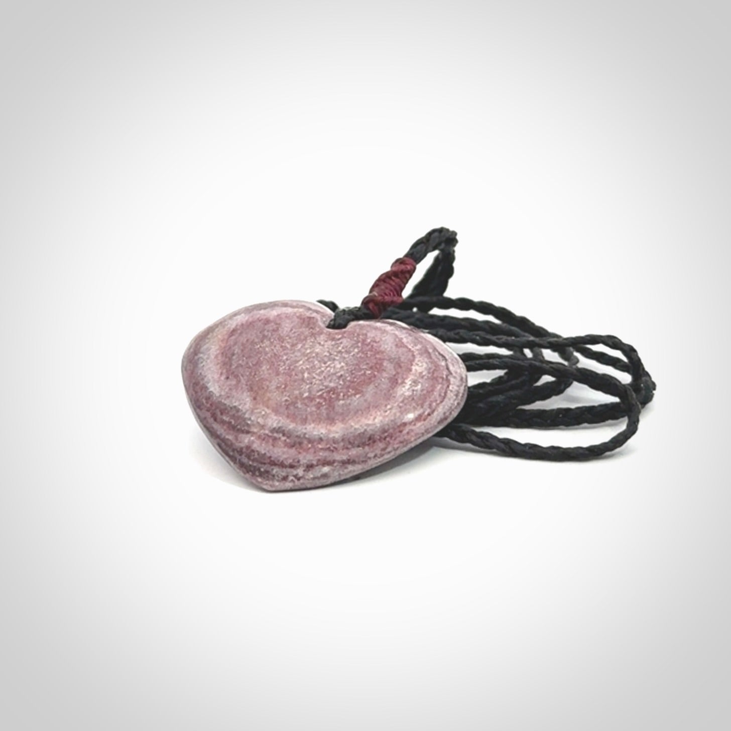 A hand carved heart pendant made from New Zealand Aroha Stone. This is a smaller sized and visually striking piece, beautifully curved and sensuous. The perfect piece of jewellery for someone you love.