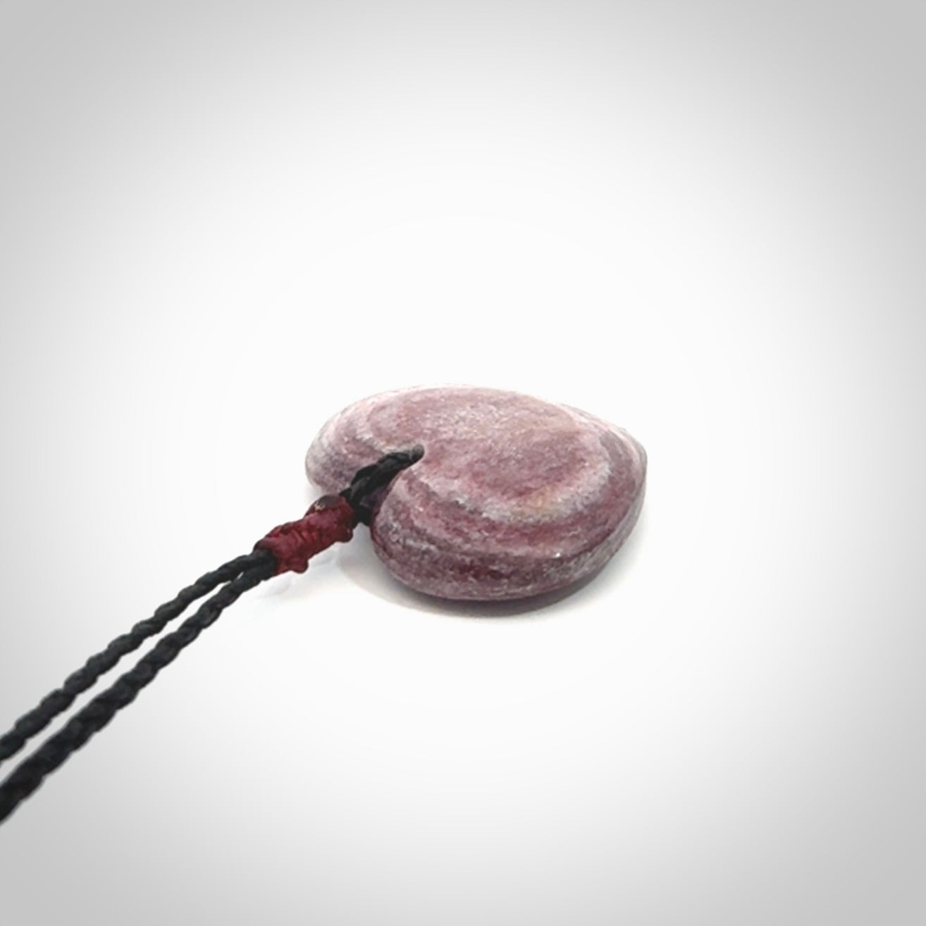 A hand carved heart pendant made from New Zealand Aroha Stone. This is a smaller sized and visually striking piece, beautifully curved and sensuous. The perfect piece of jewellery for someone you love.