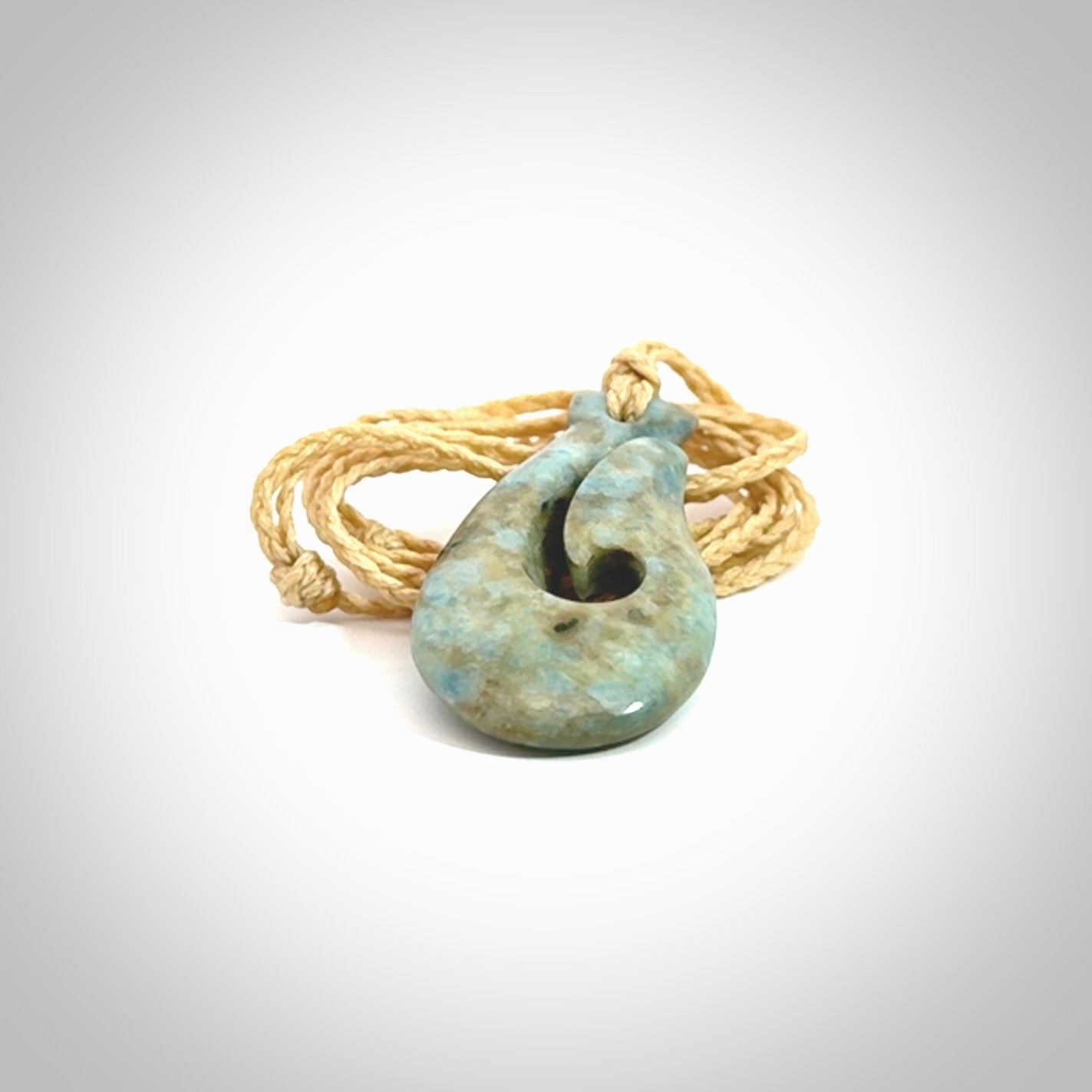 This is a handcrafted aotea stone Hook pendant.