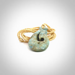 This is a handcrafted aotea stone Hook pendant.