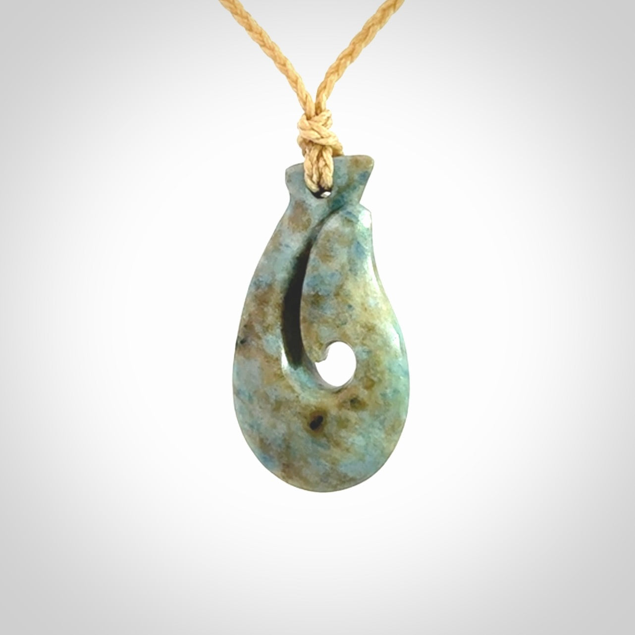 This is a handcrafted aotea stone Hook pendant.