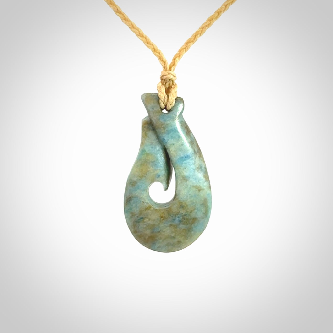 This is a handcrafted aotea stone Hook pendant.