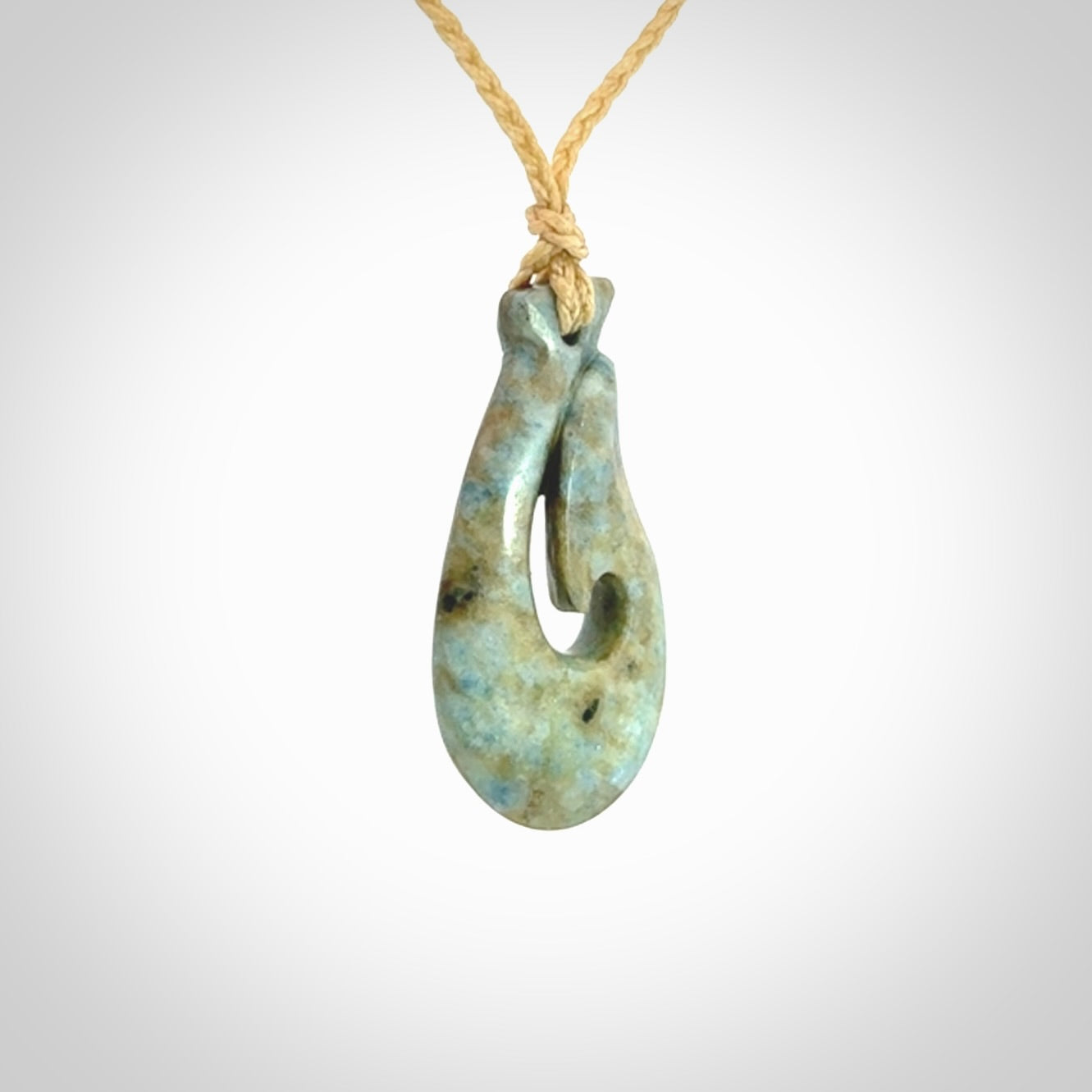 This is a handcrafted aotea stone Hook pendant.