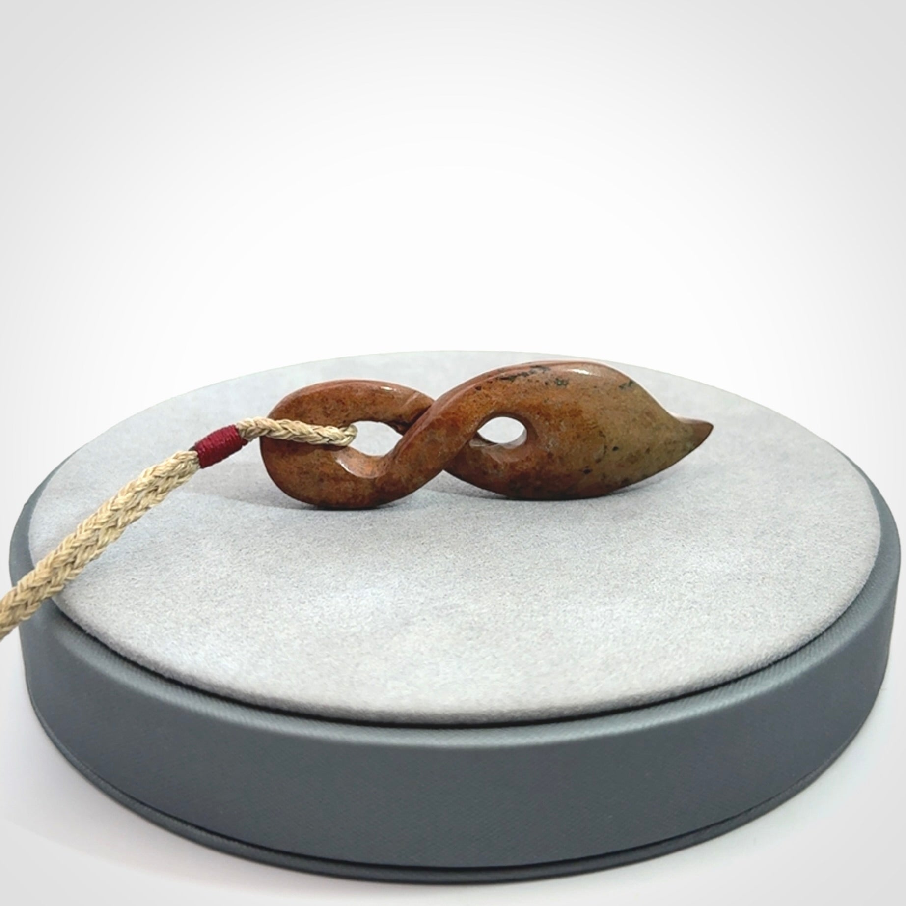A wonderful twist pendant carved in jade that has been heated
