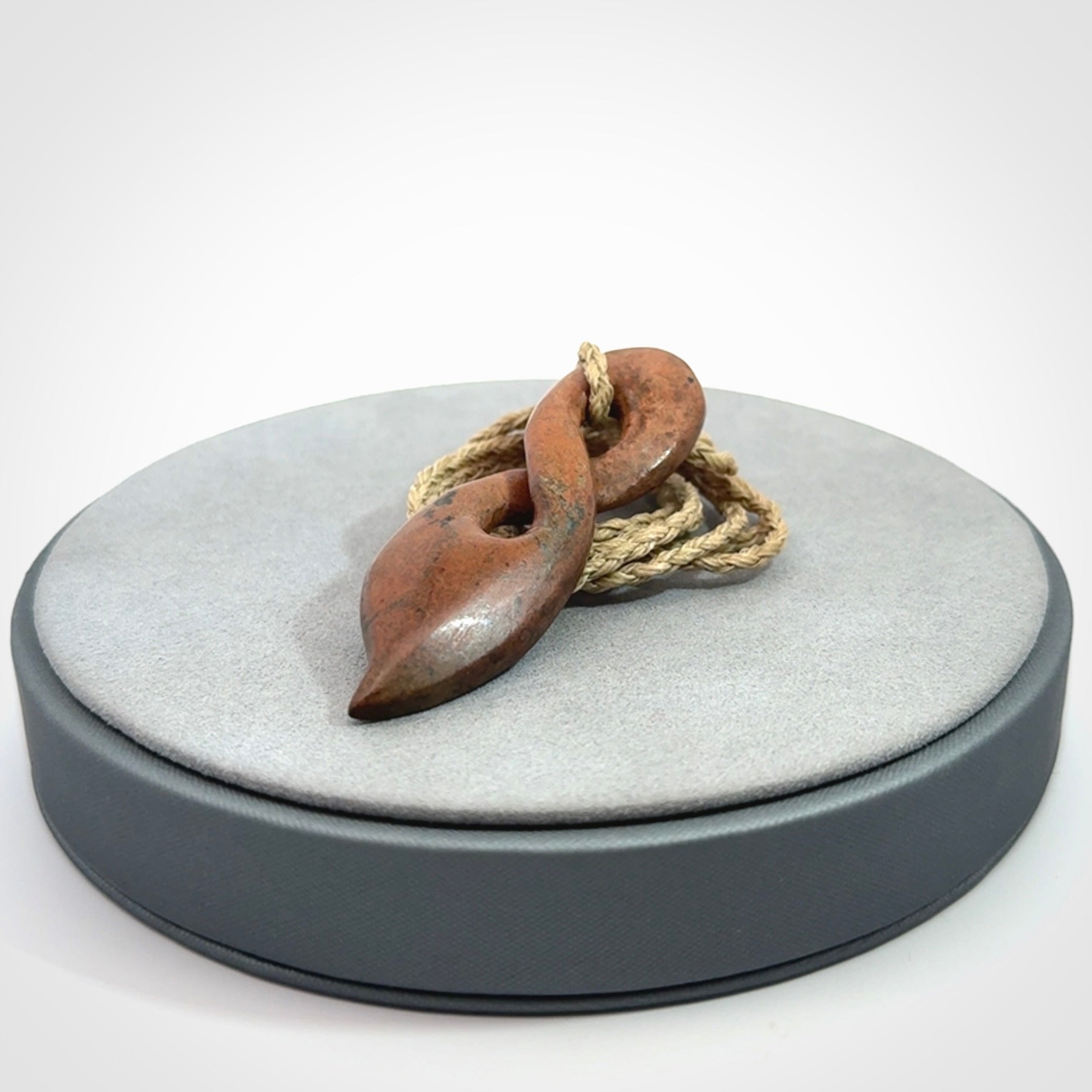 A wonderful twist pendant carved in jade that has been heated