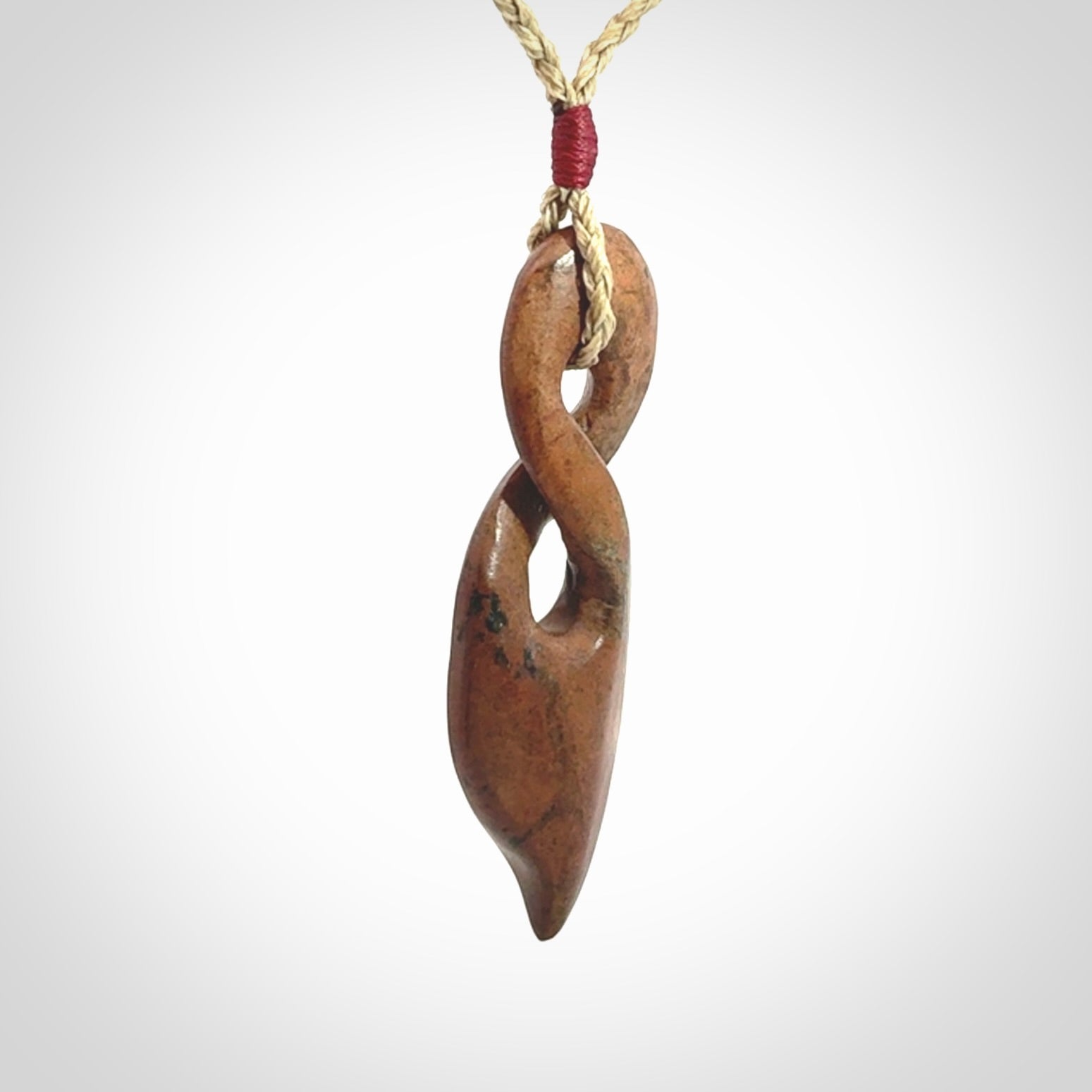 A wonderful twist pendant carved in jade that has been heated