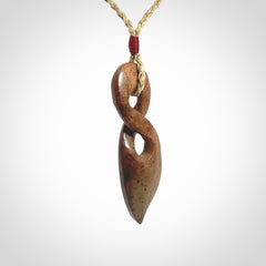 A wonderful twist pendant carved in jade that has been heated