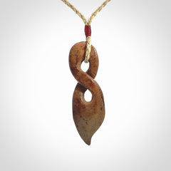 A wonderful twist pendant carved in jade that has been heated