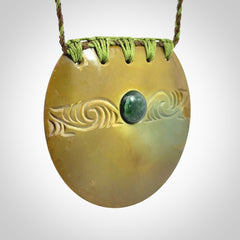 Hand carved New Zealand Flower Jade half-shield with whakarei design pendant.
