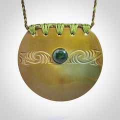 Hand carved New Zealand Flower Jade half-shield with whakarei design pendant.