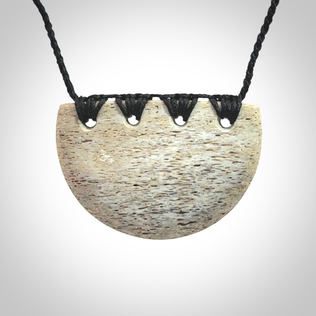 Hand carved whale bone breastplate pendant.