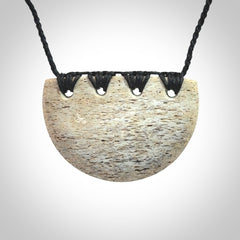 Hand carved whale bone breastplate pendant.