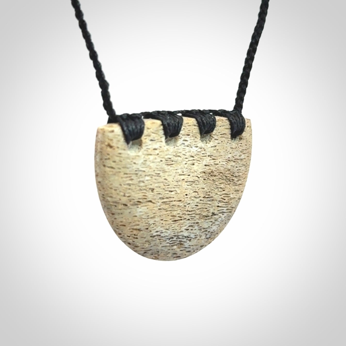 Hand carved whale bone breastplate pendant.
