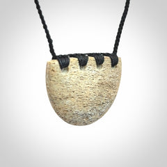 Hand carved whale bone breastplate pendant.