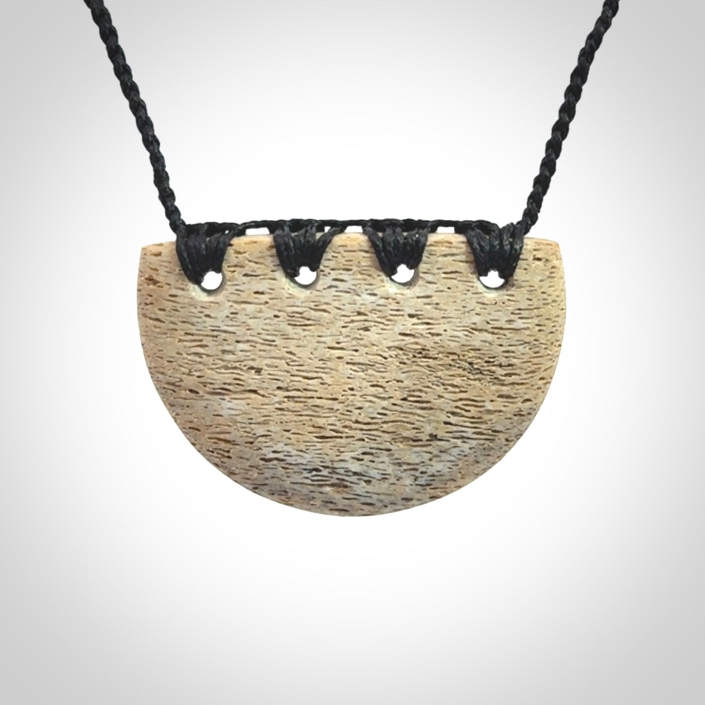 Hand carved whale bone breastplate pendant.