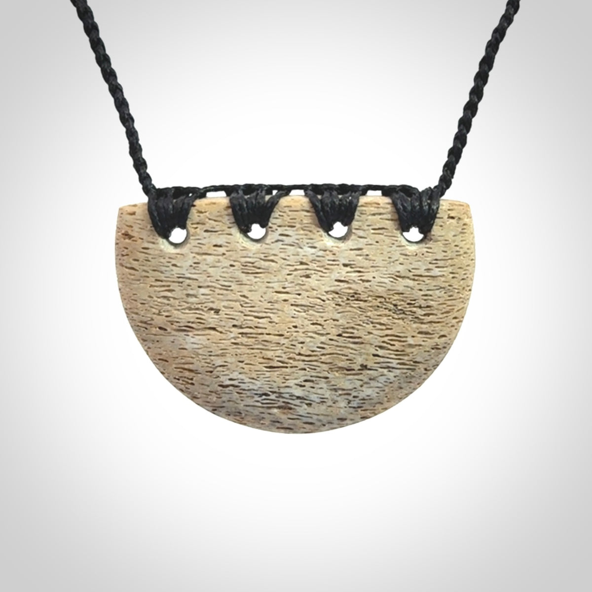 Hand carved whale bone breastplate pendant.