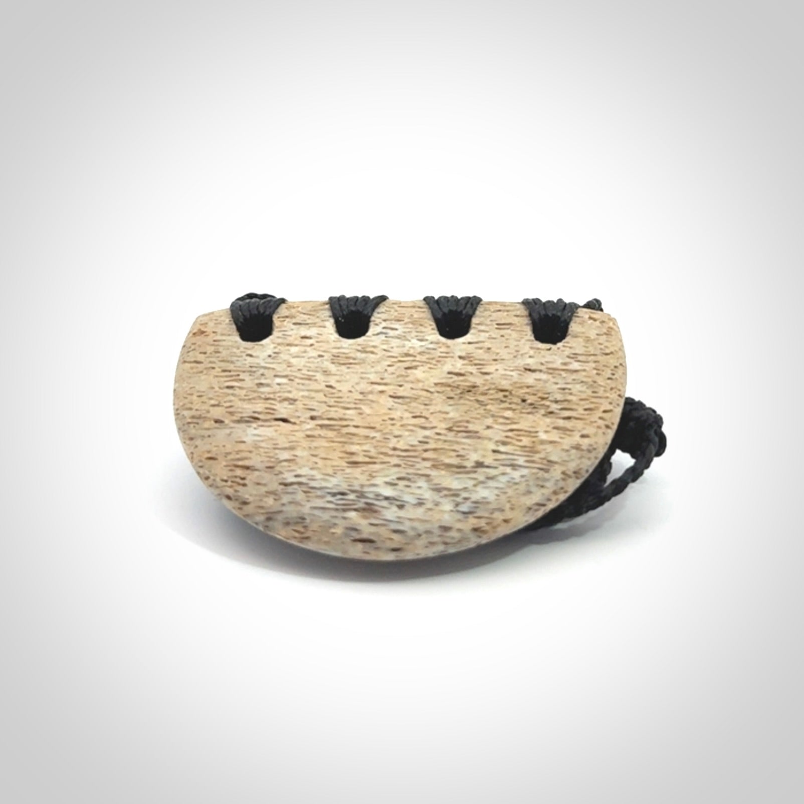 Hand carved whale bone breastplate pendant.