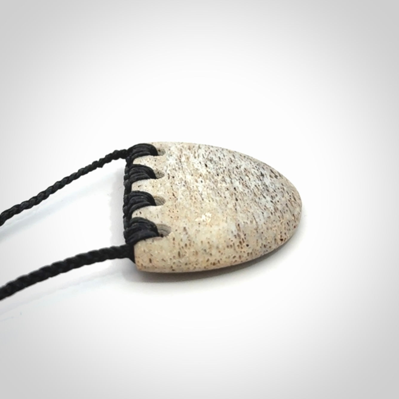 Hand carved whale bone breastplate pendant.