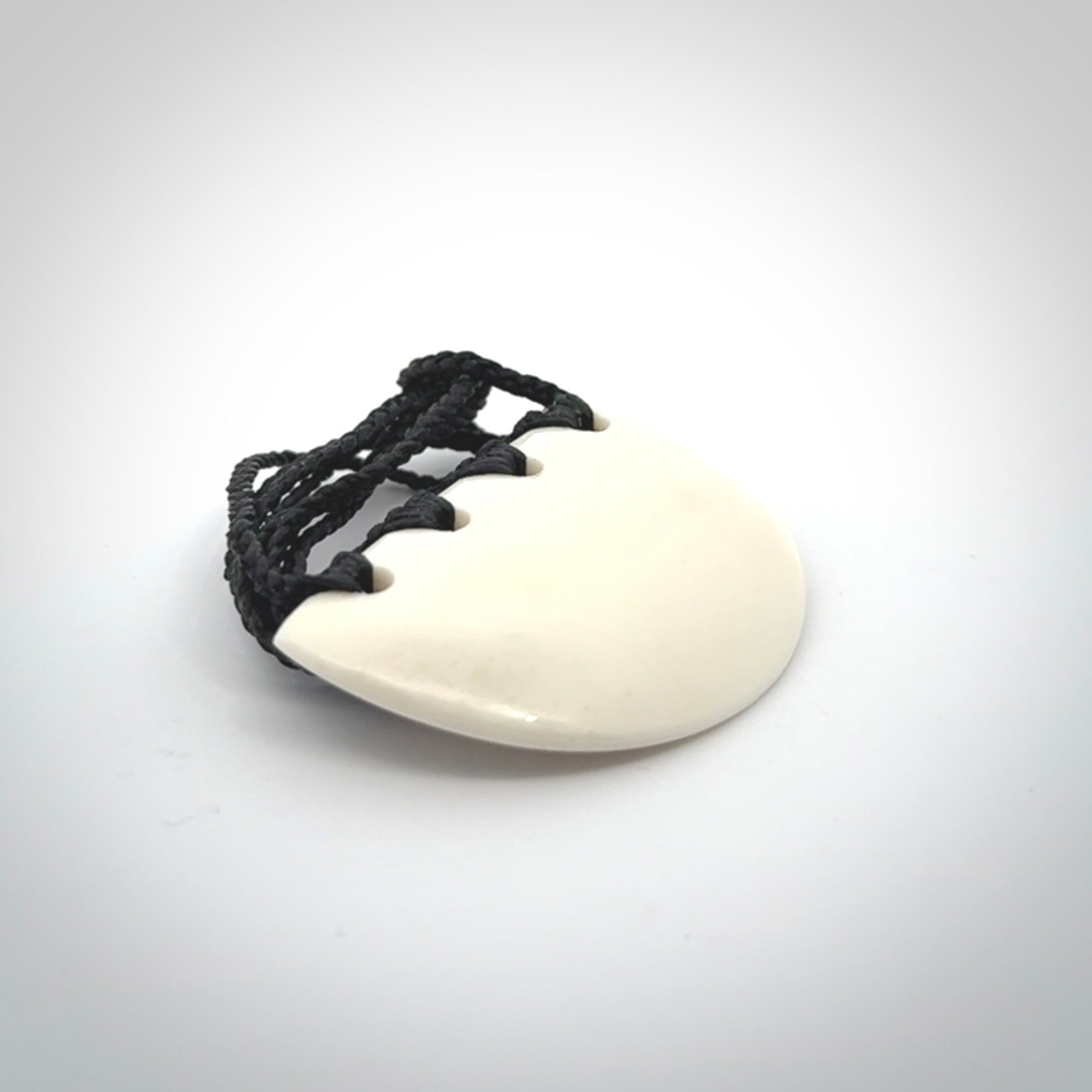 Hand carved bone breastplate pendant.