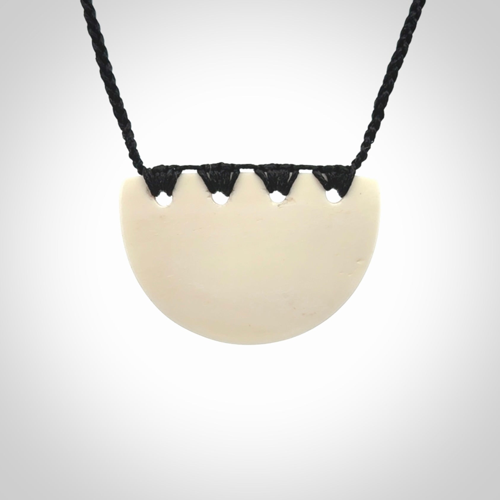 Hand carved bone breastplate pendant.