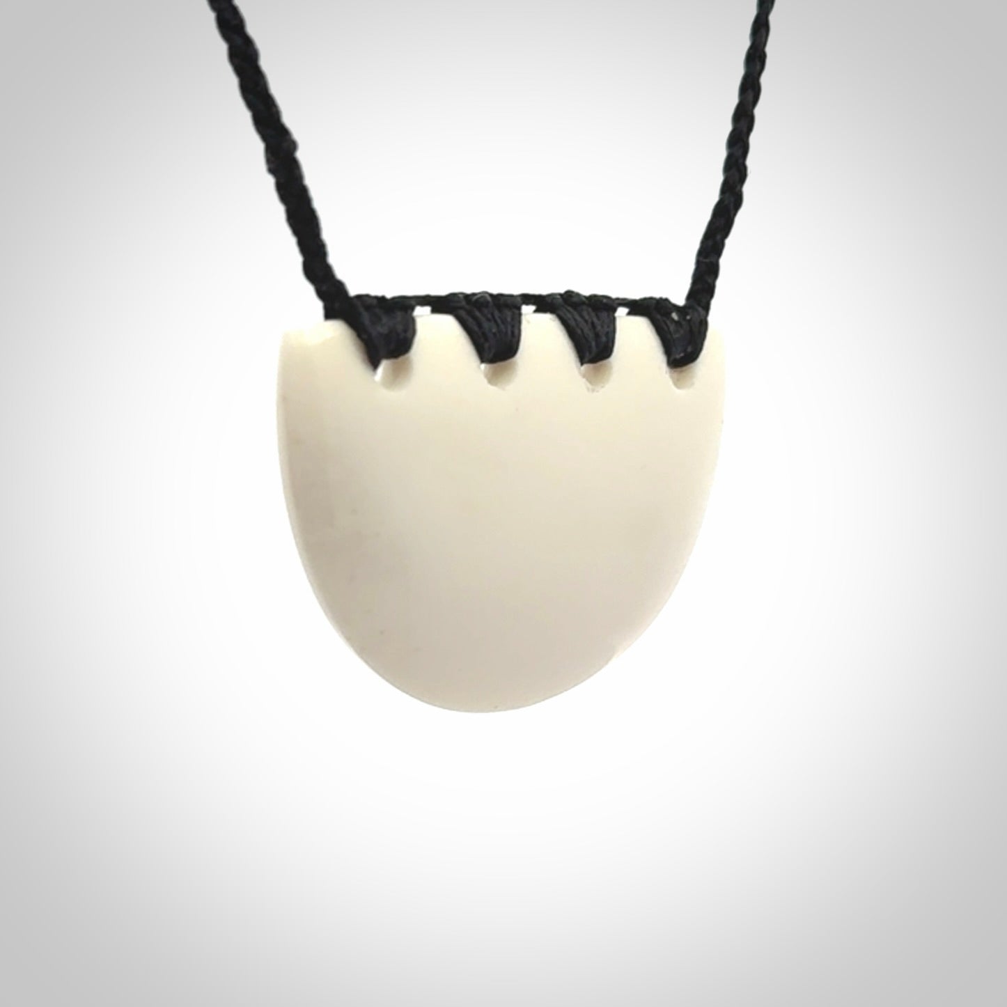 Hand carved bone breastplate pendant.