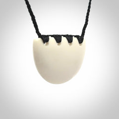 Hand carved bone breastplate pendant.