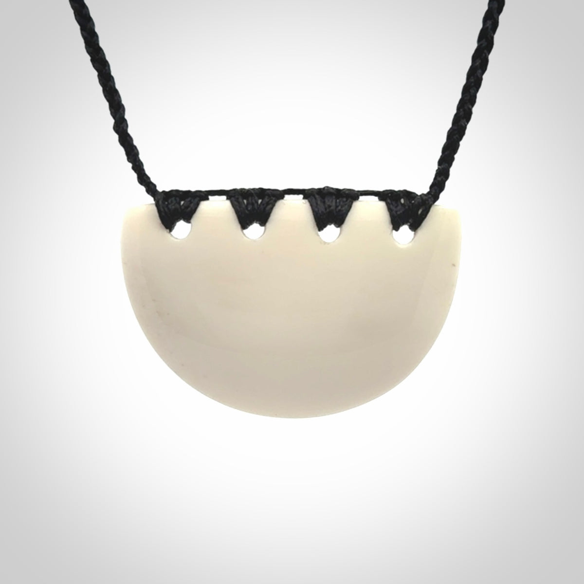 Hand carved bone breastplate pendant.