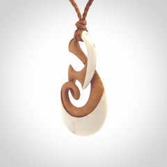 A hand carved bone contemporary, intricate twist pendant. The cord is a gingernut brown colour and is a adjustable.