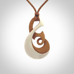 A hand carved bone contemporary, intricate twist pendant. The cord is a gingernut brown colour and is a adjustable.