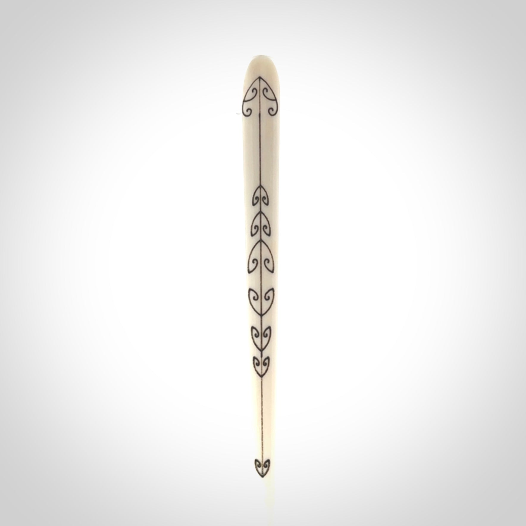Hand carved bone hair pin with double sided koru design.