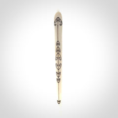 Hand carved bone hair pin with double sided koru design.