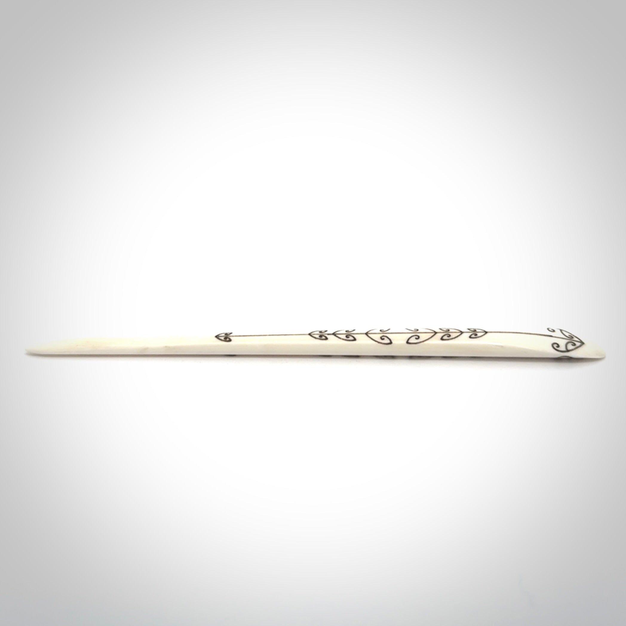 Hand carved bone hair pin with double sided koru design.