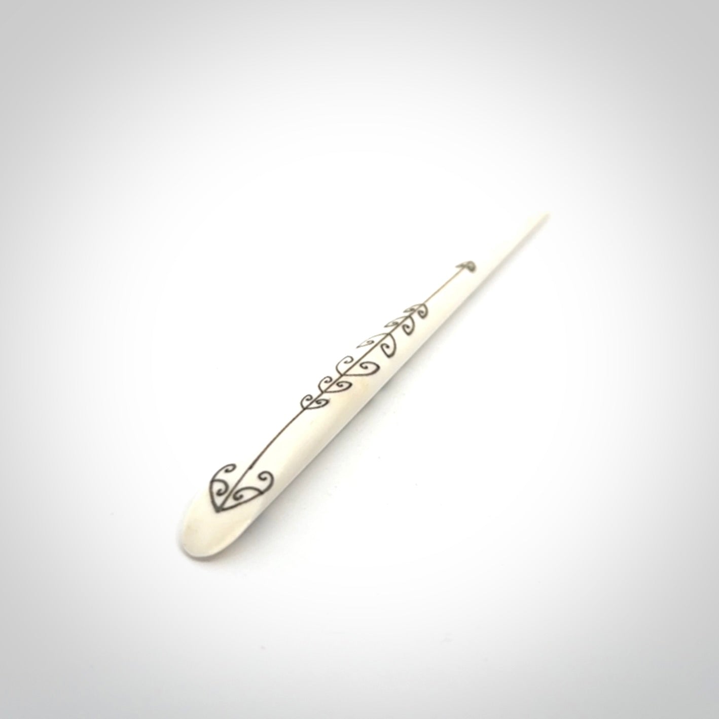 Hand carved bone hair pin with double sided koru design.