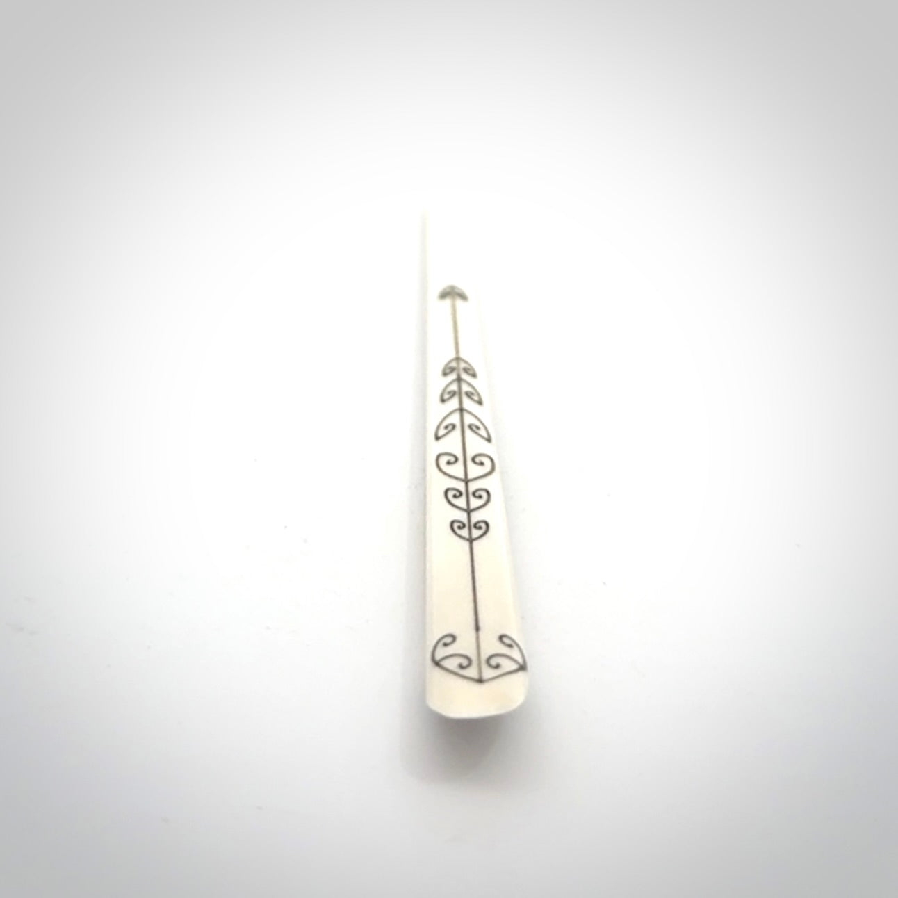 Hand carved bone hair pin with double sided koru design.