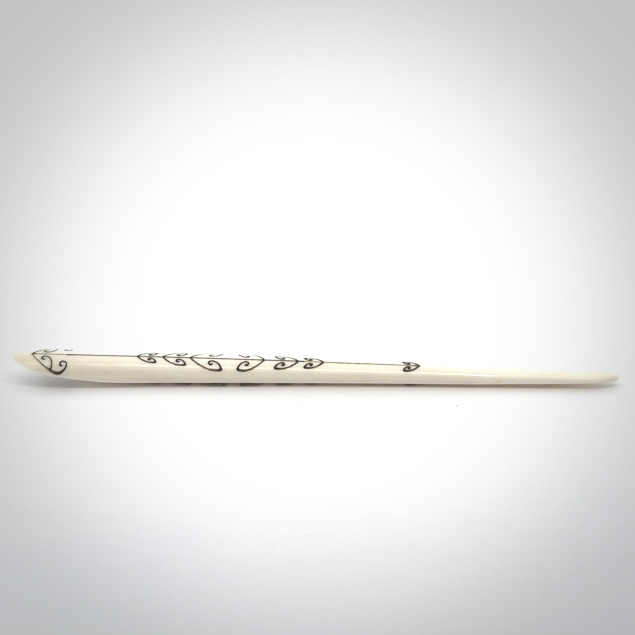 Hand carved bone hair pin with double sided koru design.