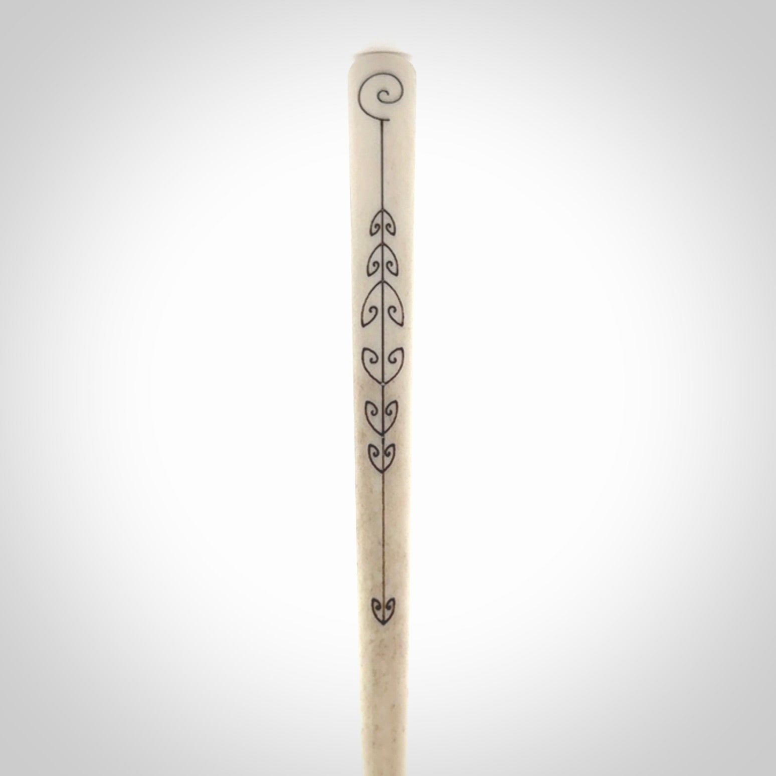 Hand carved bone hair pin with double sided koru design.