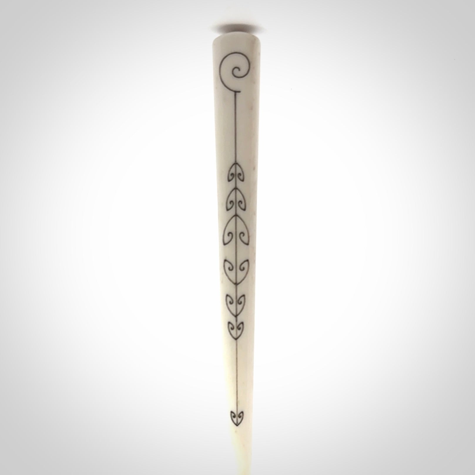 Hand carved bone hair pin with double sided koru design.