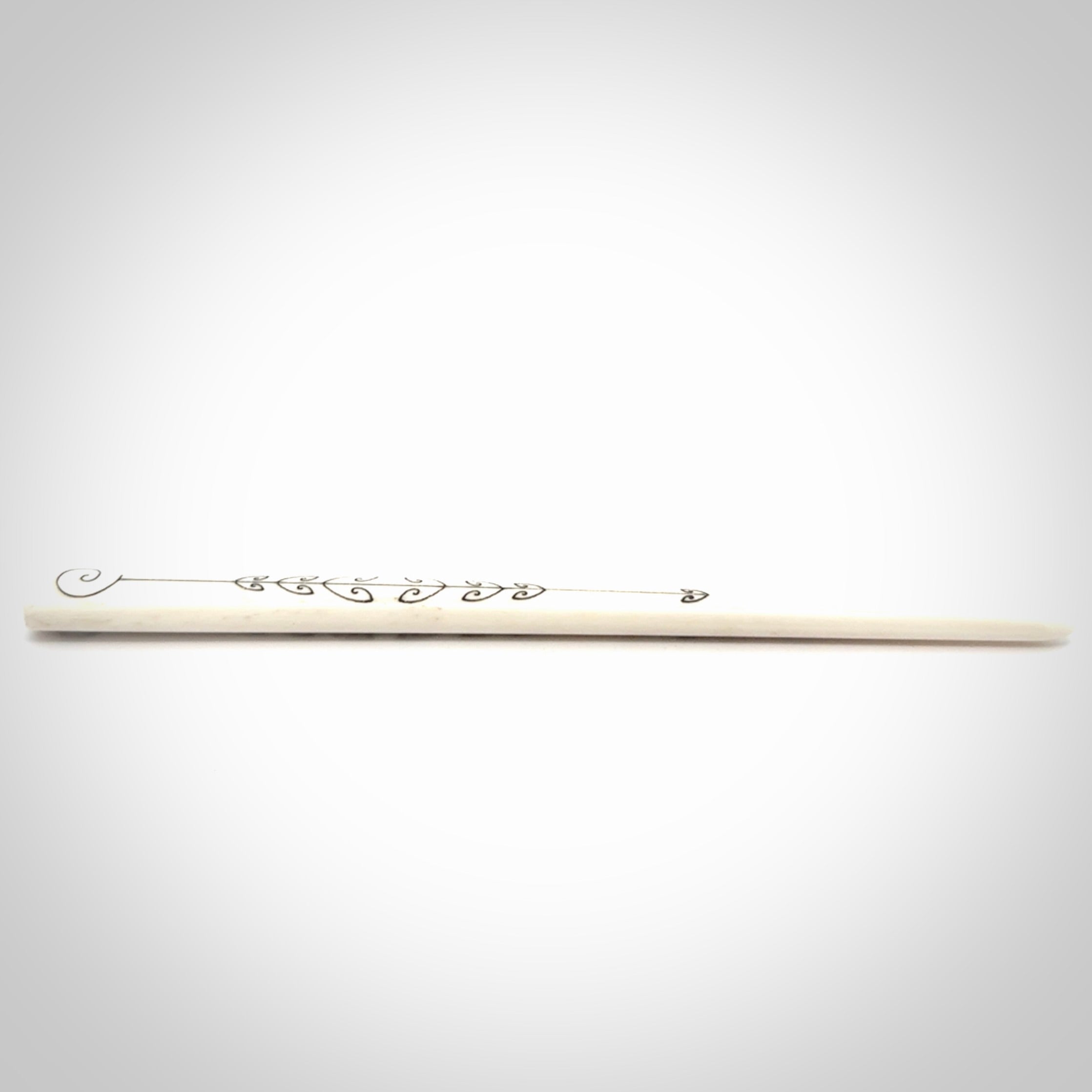 Hand carved bone hair pin with double sided koru design.