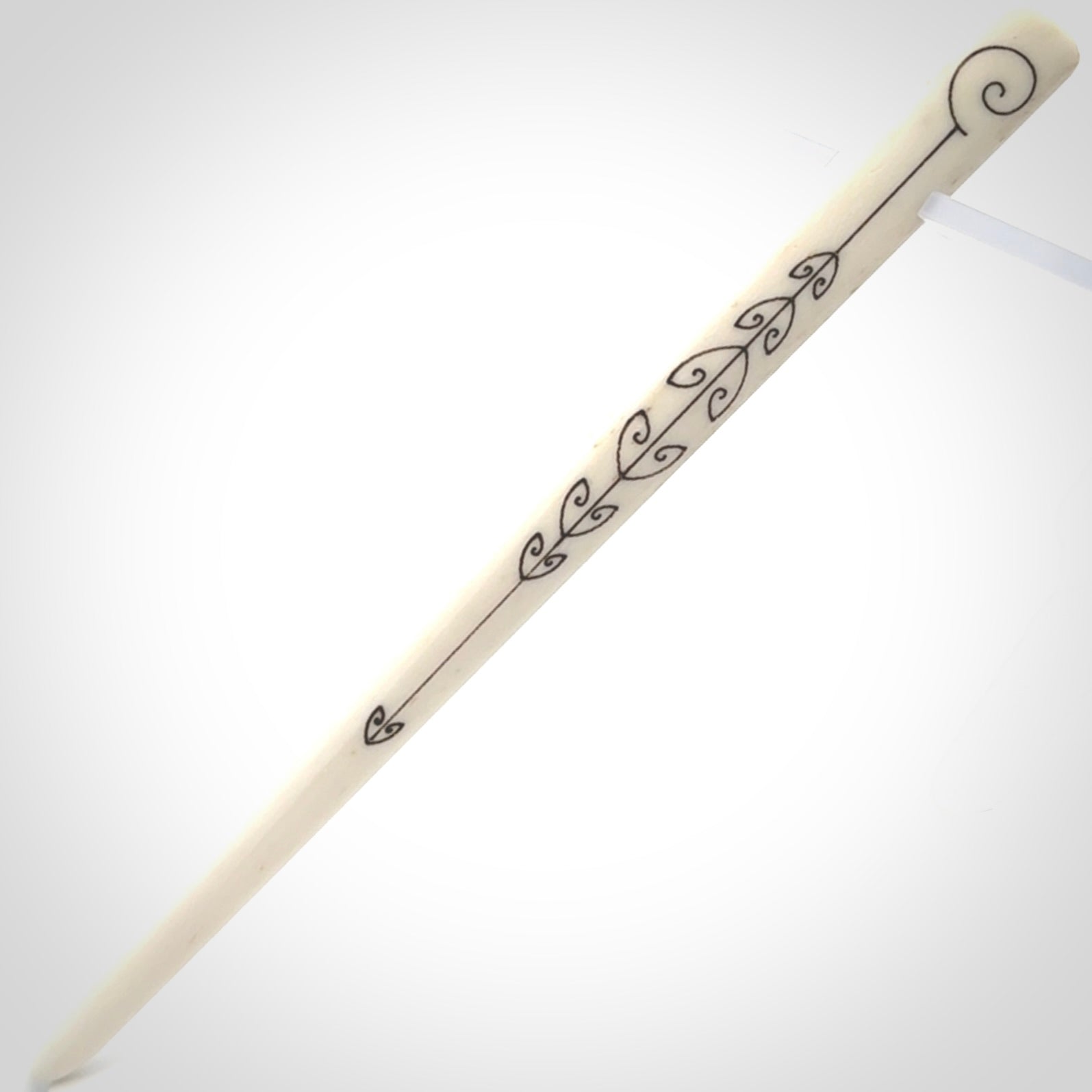 Hand carved bone hair pin with double sided koru design.