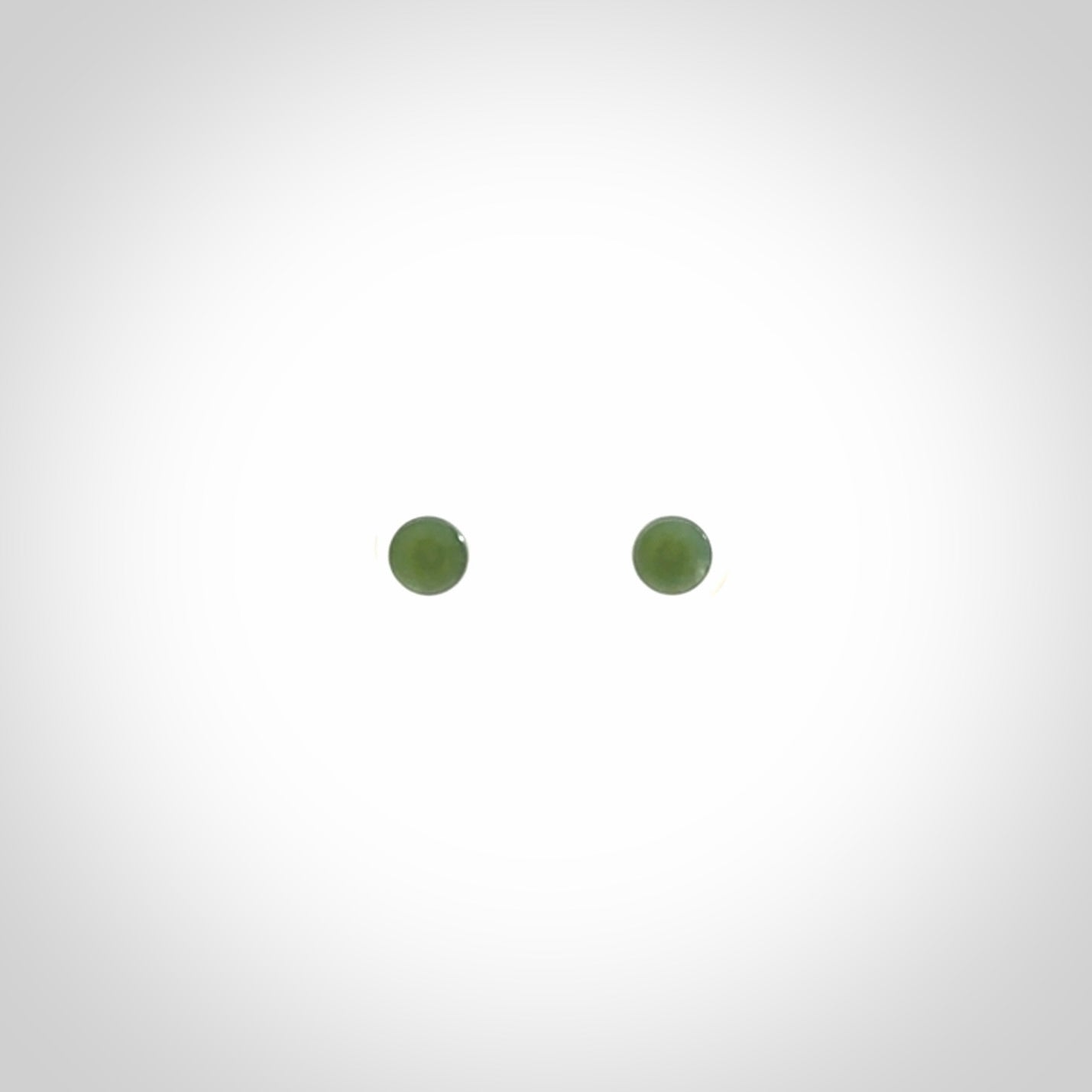 Hand carved small New Zealand Jade and Sterling Silver stud earrings.