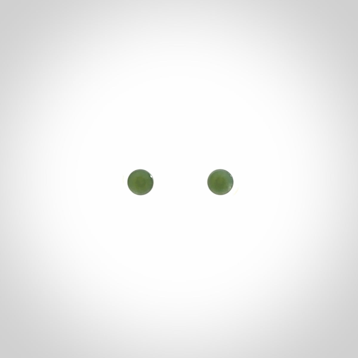 Hand carved small New Zealand Jade and Sterling Silver stud earrings.